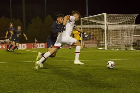 Wisconsin's Maxwell Keenan dribbles past Michigan player