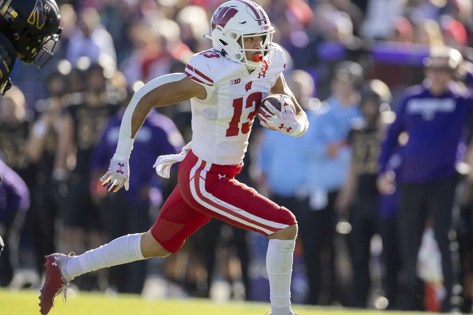 Wisconsin Badgers wide receiver Chimere Dike (13) runs in one of his three touchdowns during an NCAA Big Ten Conference college football game against the Northwestern Wildcats on Saturday, Oct. 8, 2022, in Evanston, Ill. The Badgers defeated the Wildcats, 42-7.