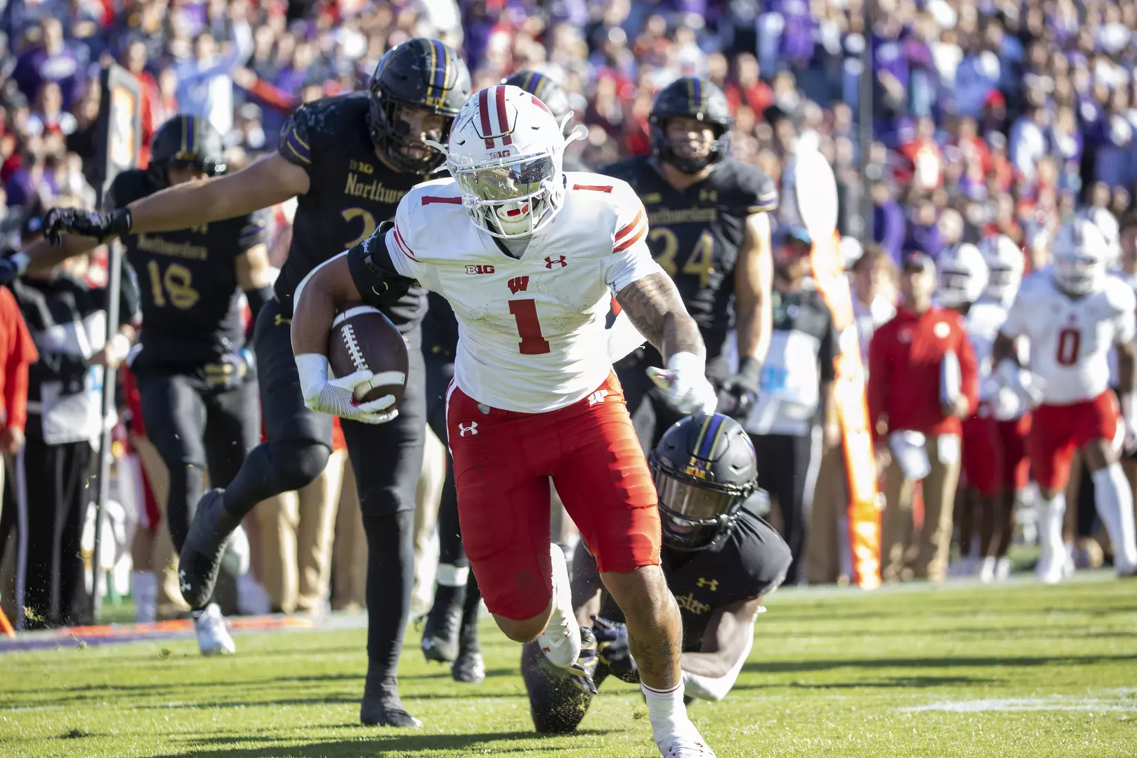 Wisconsin Badgers running back Chez Mellusi (1) scores a touchdown after receiving the pass from fellow running back Braelon Allen (0) during an NCAA Big Ten Conference college football game against the Northwestern Wildcats on Saturday, Oct. 8, 2022, in Evanston, Ill. The Badgers defeated the Wildcats, 42-7.