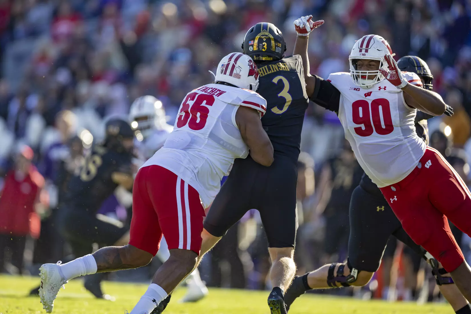 Wisconsin Badgers defensive end Rodas Johnson (Getachew) (56) and teammates James Thompson Jr. tackle quarterback Ryan Hilinski during an NCAA Big Ten Conference college football game against the Northwestern Wildcats on Saturday, Oct. 8, 2022, in Evanston, Ill. The Badgers defeated the Wildcats, 42-7.