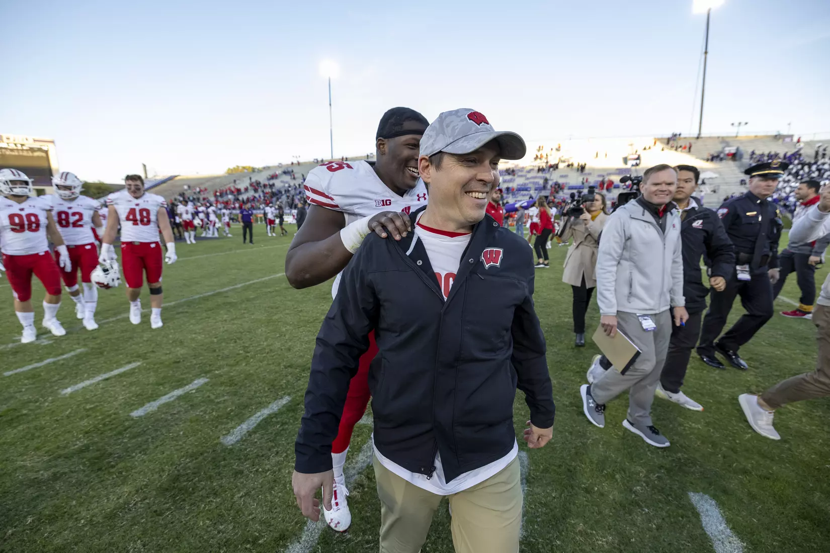 Wisconsin Badgers interim head coach Jim Leonhard receives a pat on the back from defensive tackle Keeanu Benton (95) after an NCAA Big Ten Conference college football game against the Northwestern Wildcats on Saturday, Oct. 8, 2022, in Evanston, Ill. The Badgers defeated the Wildcats, 42-7.