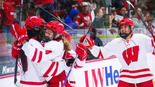 The Wisconsin women's hockey team celebrates a goal in a conference game against St. Thomas at La Bahn Arena on Oct. 8, 2022.