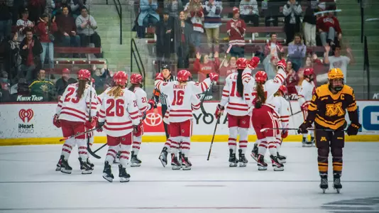 Wisconsin women's hockey celebrates a conference win against the Minnesota Gophers on November 20, 2022 at LaBahn Arena.