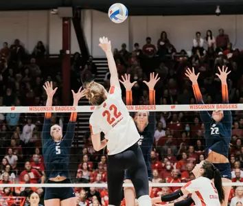 Julia Orzol hits against three Illinois blockers.