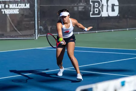 Xinyu Cai returns the ball during a match