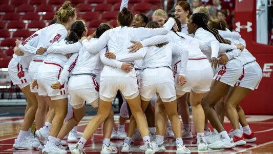 The women's basketball team in a huddle