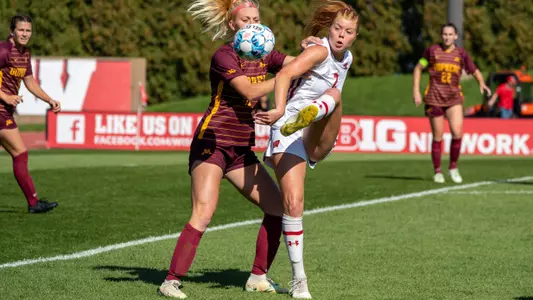 Emma Jaskaniec taking a touch with a defender next to her