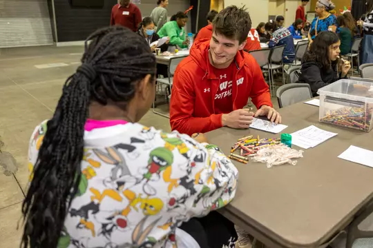 Wisconsin Badgers football team volunteers at a Salvation Army Christmas event in Phoenix, Arizona. (Photo by David Stluka/Wisconsin Athletic Communications)