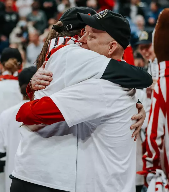 Wisconsin volleyball head coach Kelly Sheffield hugs Danielle Hart after the Badgers won the 2021 NCAA Championships