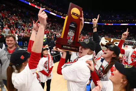 COLUMBUS, OH - DECEMBER 18: Wisconsin Badgers players celebrate their win over the Nebraska Cornhuskers in the Division I Women?s Volleyball Championship on December 18, 2021 in Columbus, Ohio. (Photo by Jamie Schwaberow/NCAA Photos via Getty Images)
