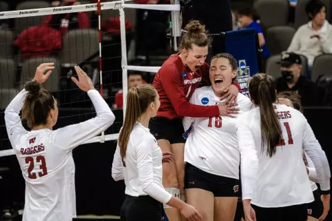 Lauren Barnes jumps on Danielle Hart in celebration - Wisconsin volleyball