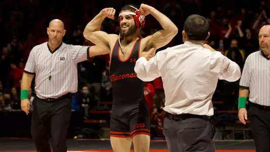 Eric Barnett flexes to the crowd in celebration after pinning his opponent during Wisconsin's dual match against Illinois on Friday, Feb. 11, 2022 at the UW Field House.