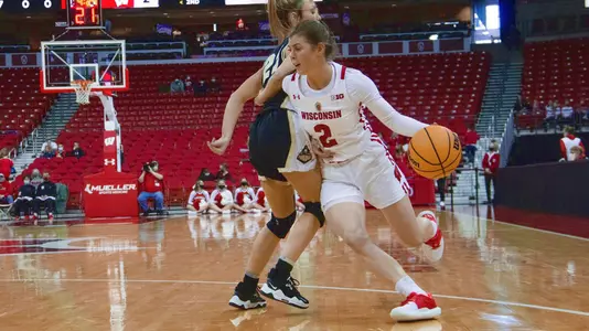 Katie Nelson drives around a Purdue defender.