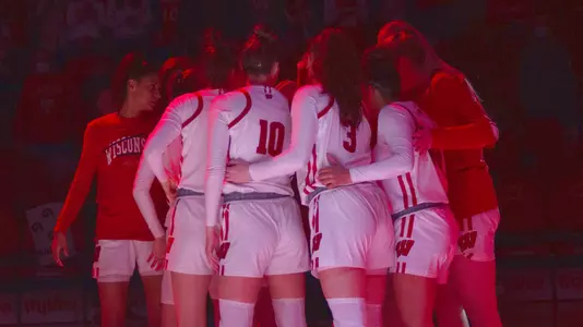 The Badgers huddle up on the floor before a game.