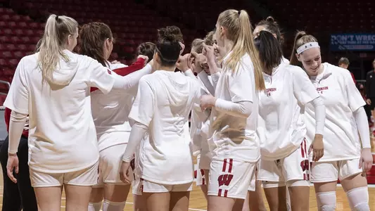 The Badgers huddle up on the court before a game.