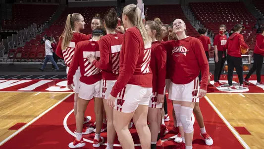 The Badgers huddle up at center court of the Kohl Center.