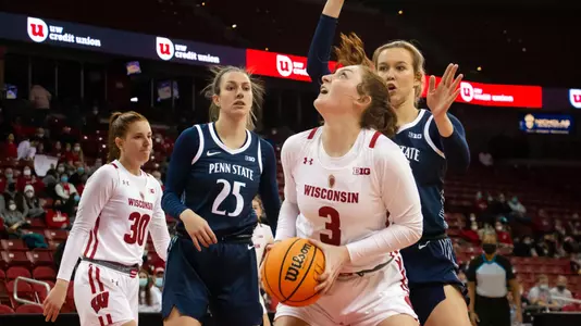 Brooke Schramek shoots under the basket against a Penn State defender.