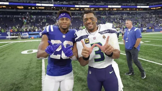 Jonathan Taylor and Russell Wilson pose after an NFL game at Lucas Oil Stadium
