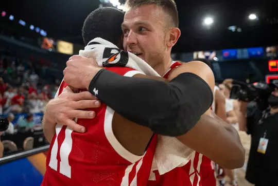 Brad Davison embraces teammate Lorne Bowman
