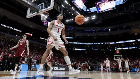 Johnny Davis celebrates after a dunk during an NCAA tournament game vs. Colgate