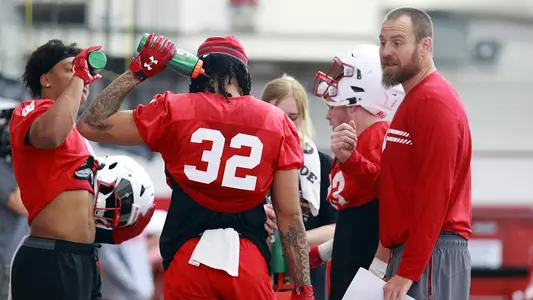 Al Johnson coaches RB Julius Davis (32) and RB Braelon Allen (0) during spring practice on March 23, 2022