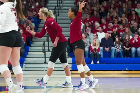 Sydney Reed and MJ Hammill celebrate with volleyball team vs. Marquette, April 10