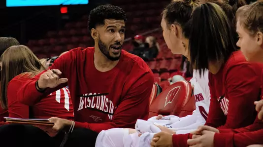 Scott Merritt talks to players on the bench.