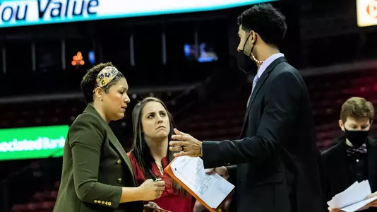 Coaches Moseley, Merritt and Doty talk during a time out.