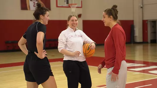 Kate Barnosky and Caroline Doty chat with Julie Pospisilova during practice.