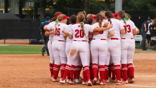 Softball huddle vs. Minnesota
