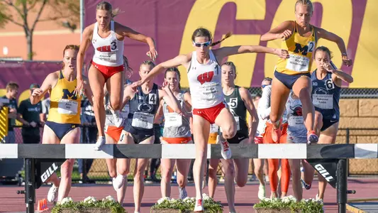 Alissa Niggemann and Lucinda Crouch go over the water barrier in the steeplechase