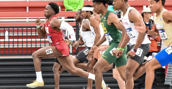 Lawrence Johnson leads the field in the 100 meters.