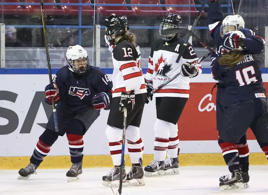 DMITROV, RUSSIA - JANUARY 9: USA's Britta Curl #14 celebrates after her teammate Dominique Petrie #11 scores against Canada to make it 1-0 team USA in the first period during preliminary round action at the 2018 IIHF Ice Hockey U18 Women's World Championship. (Photo by Francois Laplante/HHOF-IIHF Images)