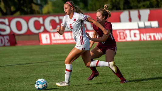 Maddie Ishaug dribbling off a Loyola defender