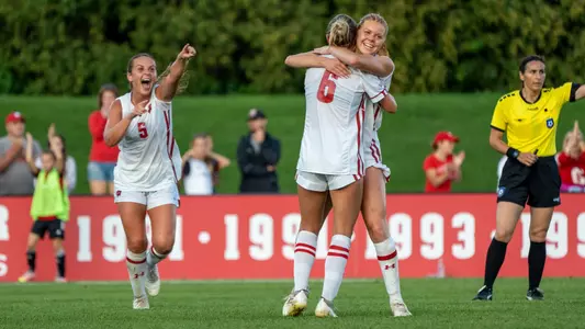 The women's soccer team celebrating a goal vs. Green Bay