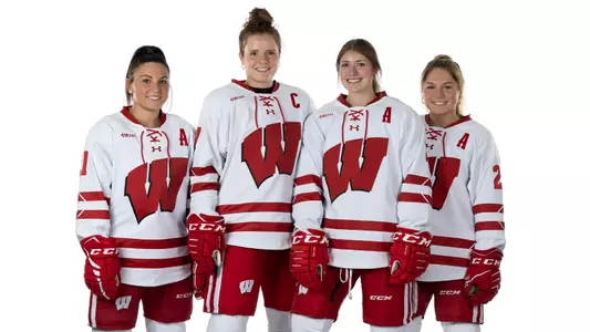 Portrait of captains Nicole Lamantia (21), left to right, Britta Curl (17), Natalie Buchbinder (2) and Casey Oâ??Brien (26) of the Wisconsin Badgers Womenâ??s Hockey Team, Wednesday, Sept. 14, 2022 in Madison, Wis. Photo by David Stluka/Wisconsin Athletic Communications)