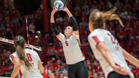 MJ Hammill sets up the ball while Danielle Hart and Julia Orzol wait to hit.