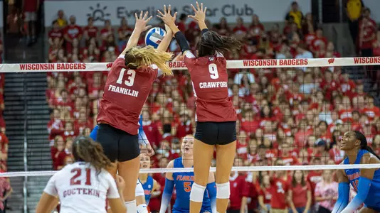 Sarah Franklin and Caroline Crawford go up for a block against a Florida hitter.
