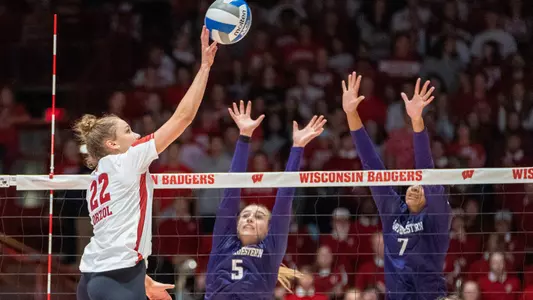 Julia Orzol goes up for a kill against two Northwestern blockers.