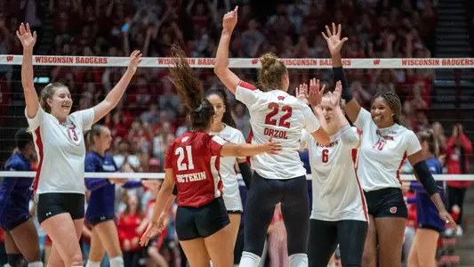The Badgers celebrate a point on the court.