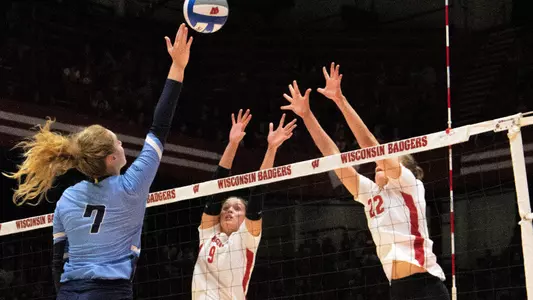 Caroline Crawford and Julia Orzol go up for a block against a Marquette hitter.
