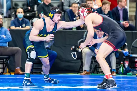 Wisconsin wrestler Dean Hamiti wrestles Michigan's Cameron Amine at the 2022 NCAA Championships in Detroit, Michigan.