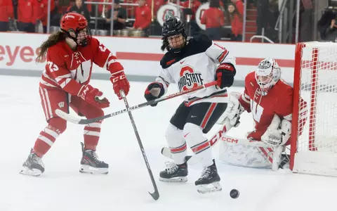 Wisconsin women's hockey Jane Gervais and Sarah Wozniewicz look down a puck against Ohio State on Jan. 14, 2023
