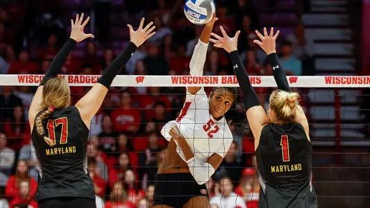 Carter Booth hits between two Maryland blockers