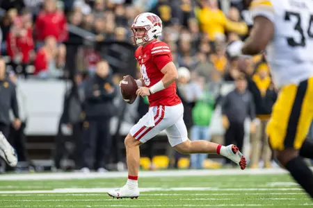 Wisconsin Badgers quarterback Braedyn Locke (18) rolls out of the pocket during a Big Ten Conference NCAA college football game against the Iowa Hawkeyes, Saturday, Oct. 14, 2023, in Madison, Wis. The Hawkeyes won 15-6. (Photo by David Stluka/Wisconsin Athletic Communications)
