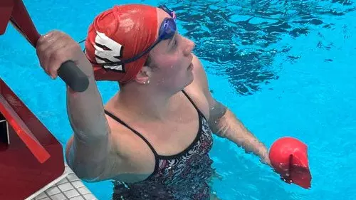 Maddie Waggoner holds on to the starting block after the 1000 free