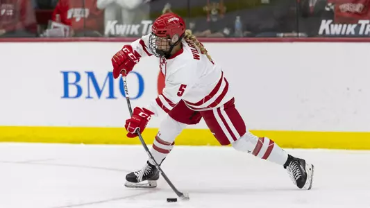 Anna Wilgren shoots the puck against Boston College