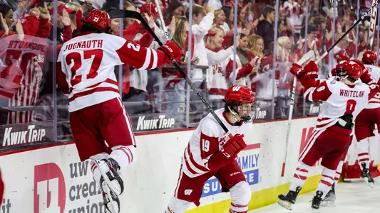 Members of the Wisconsin men's hockey team celebrate a win