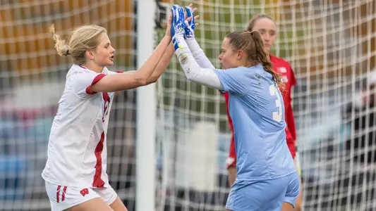 Hailey Baumann and Erin McKinney celebrate against Rutgers