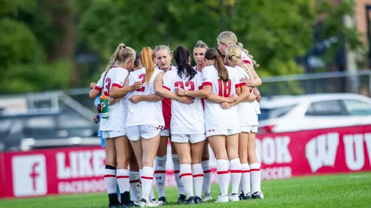 The Badgers in a huddle prior to the start of a match